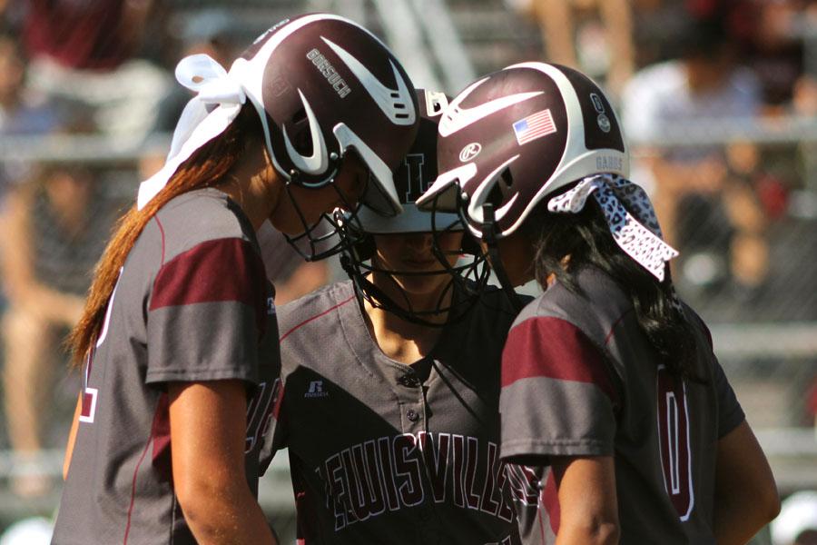 Sophomore Maribeth Gorsuch, junior Gaby Vasquez, and sophomore Tommi Godman huddled before the next inning began during the Mansfield Timeberview game on May 10.