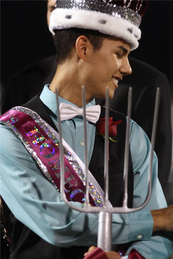 Senior Joseph Garcia smiling happily after being crowned Homecoming King.