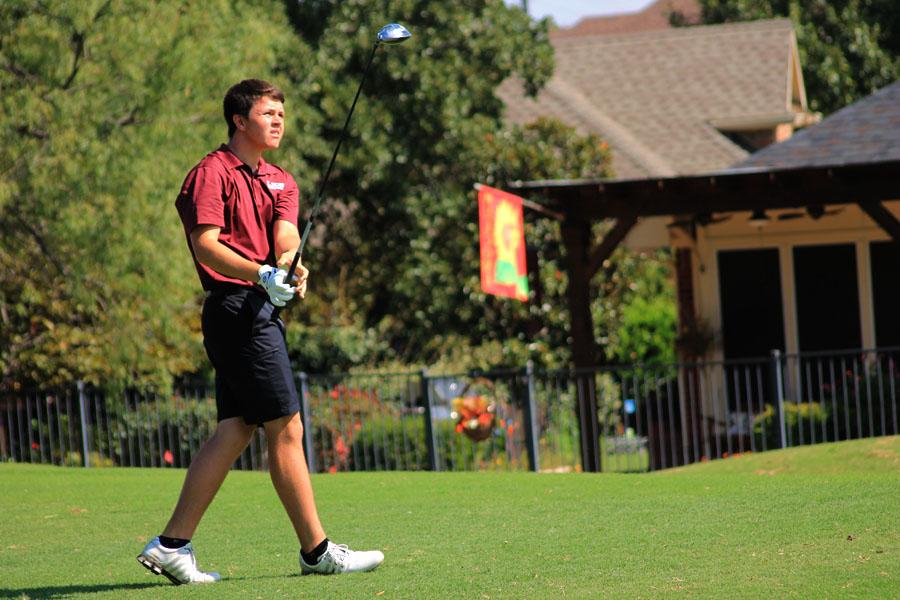 Senior John Shofner watches as the golf ball hits the ground.