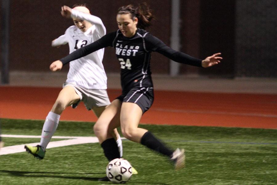 Junior Kandis Hartdegen fights for the ball against the Plano West on Feb. 3.