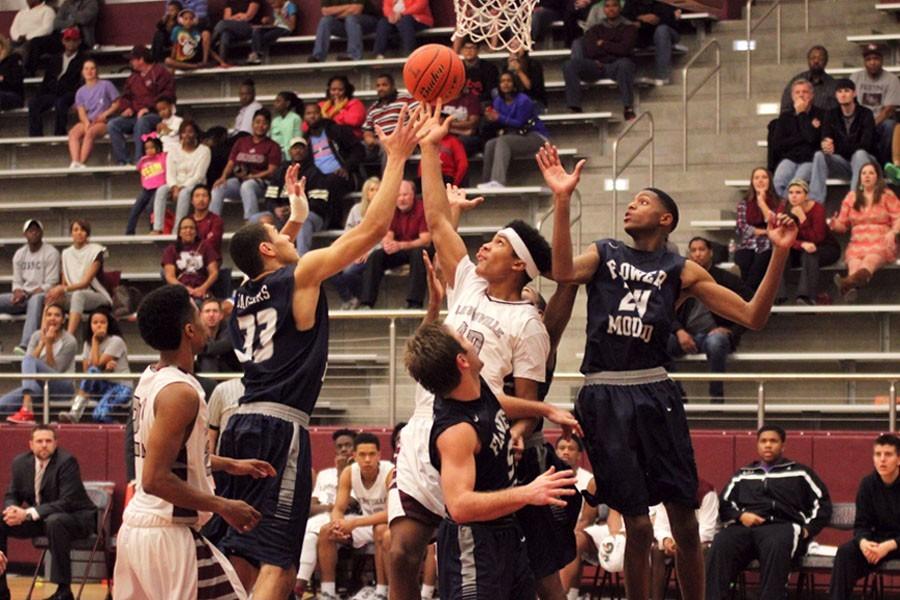Senior Anthony Davis (40) attempts to tip the ball into the basket against Flower Mound.