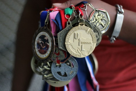 Senior Brittany Marshall clutches a handful of the medals she's won over the years. 