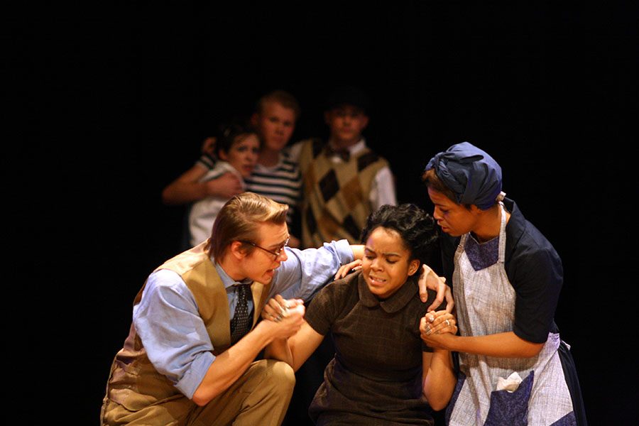 Atticus, played by senior Tallon Coxe, and Calpurnia, played by senior Destinee Gines, try to comfort Helen Robinson, played by junior Eboni Rodgers, when receiving the news of Tom Robinson's death.