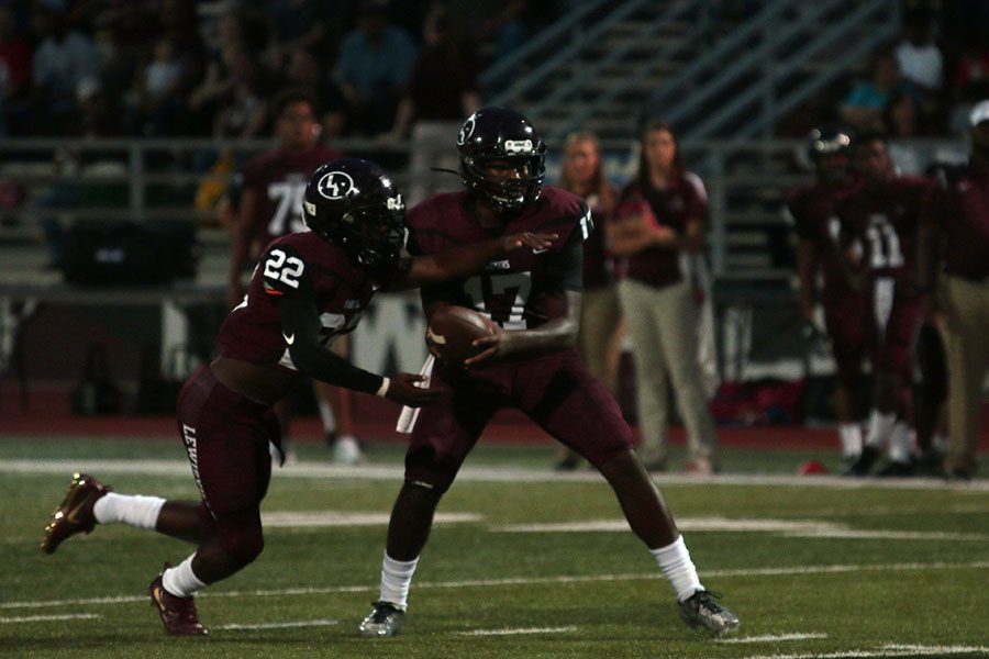 Quarterback+Jarvis+Brooks+%2817%29+hands+the+ball+to+running+back+Kwame+Mickels+%2822%29+at+the+game+on+Friday%2C+Aug.+26+against+the+Rowlett+Eagles.