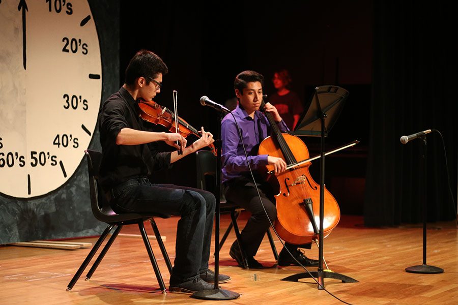 Seniors Daniel Mooney and Ulises Moreno perform a string duet of