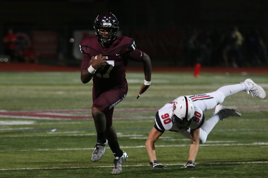 Senior quarterback Jarvis Brooks (17) runs the ball while Marcus High School's senior defensive end Brett Brown (90) misses the tackle.
