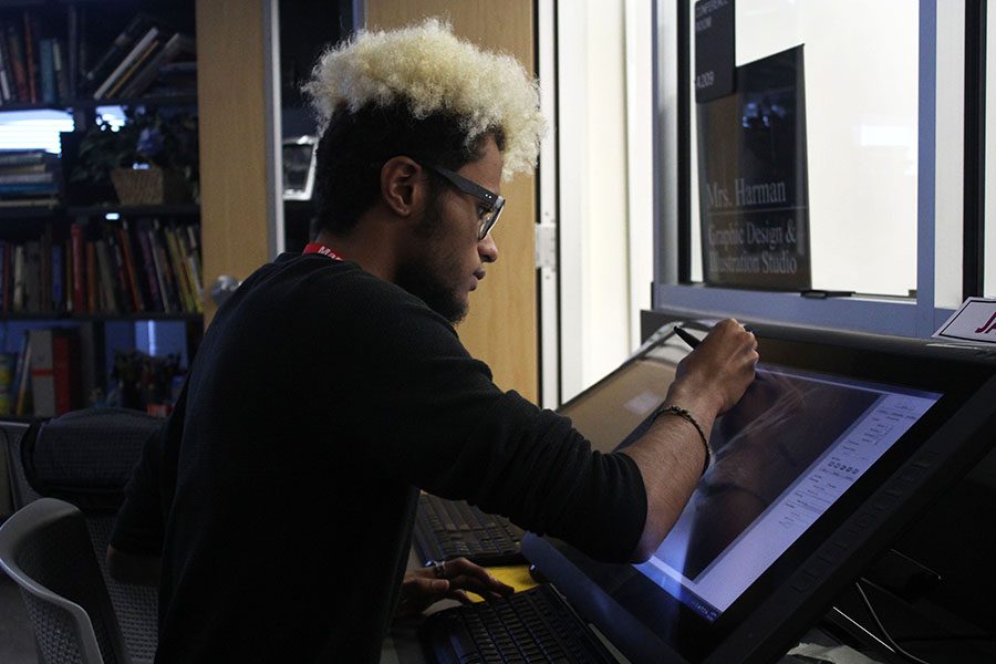 Senior Javon Dixon works intently on his project for graphic design.