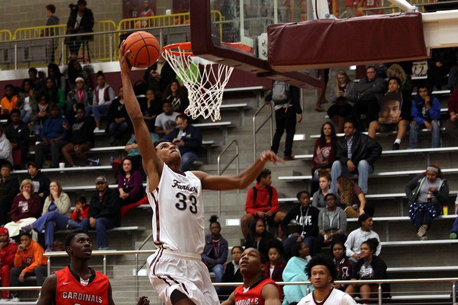 Junior Jydonn Griffith (33) dunks the ball to maintain the lead in the fourth quarter.