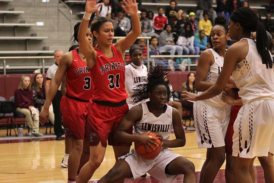 Sophomore Nala Hemingway (15) shields the ball from the defenders.