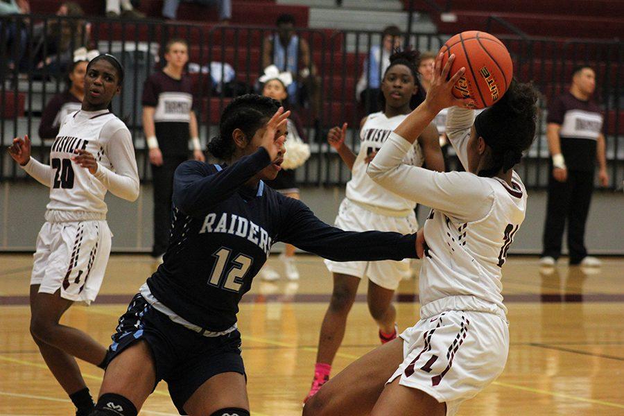 Junior+McKenzie+Bowie+%2824%29+looks+to+pass+the+ball+to+senior+Sharmaine+Harper+%2820%29+or+sophomore+Nala+Hemingway+%2815%29+during+the+L.D.+Bell+game+on+Friday%2C+Feb.+3.