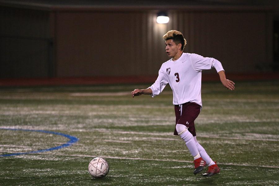 Senior+varsity+player+Abraham+Escamilla+%283%29+looks+to+shoot+for+a+goal+during+the+Byron+Nelson+game+on+Friday%2C+March+3.