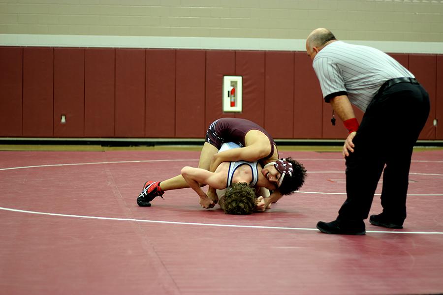 Sophomore Vinny Hill pins down a Flower Mound wrestler.