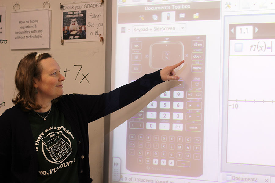 Algebra+teacher+Leigh+Ann+Mitchell+assists+students+in+solving+an+equation.