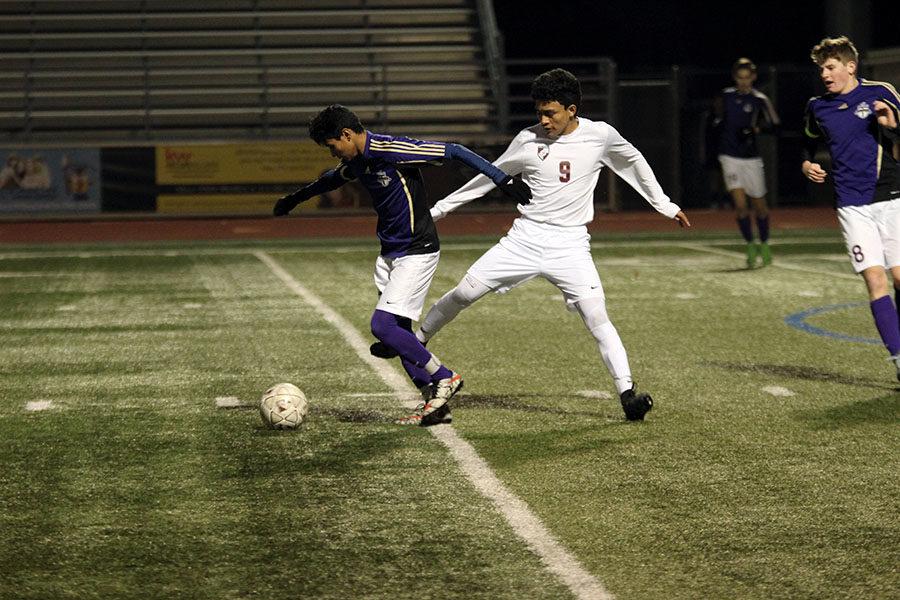 Sophomore+Fernando+Gonzalez+attempts+to+disrupt+the+opposing+teams+dribble+during+the+game+against+Timber+Creek+High+School+on+Friday%2C+Jan.+19.