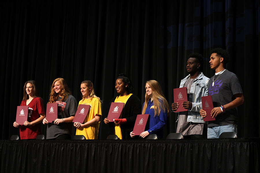 All+seven+National+Signing+Day+honorees+display+their+signed+contracts+on+Wednesday%2C+Feb.+7.