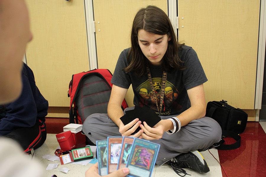 Senior+Simon+Duncan+competes+in+a+Yu-Gi-Oh%21+placement+tournament+during+lunch+on+Thursday%2C+March+1.