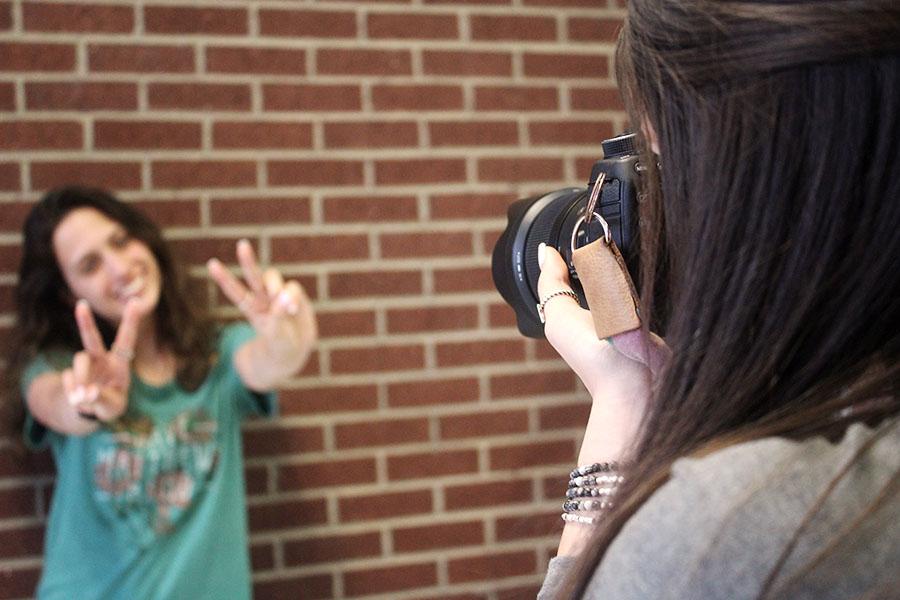 Senior Marissa Alvarez takes photos for a fellow student.