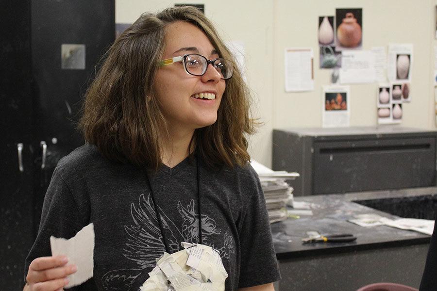 Junior+Sarah+Ross+speaks+to+one+of+her+friends+while+working+on+an+art+project.