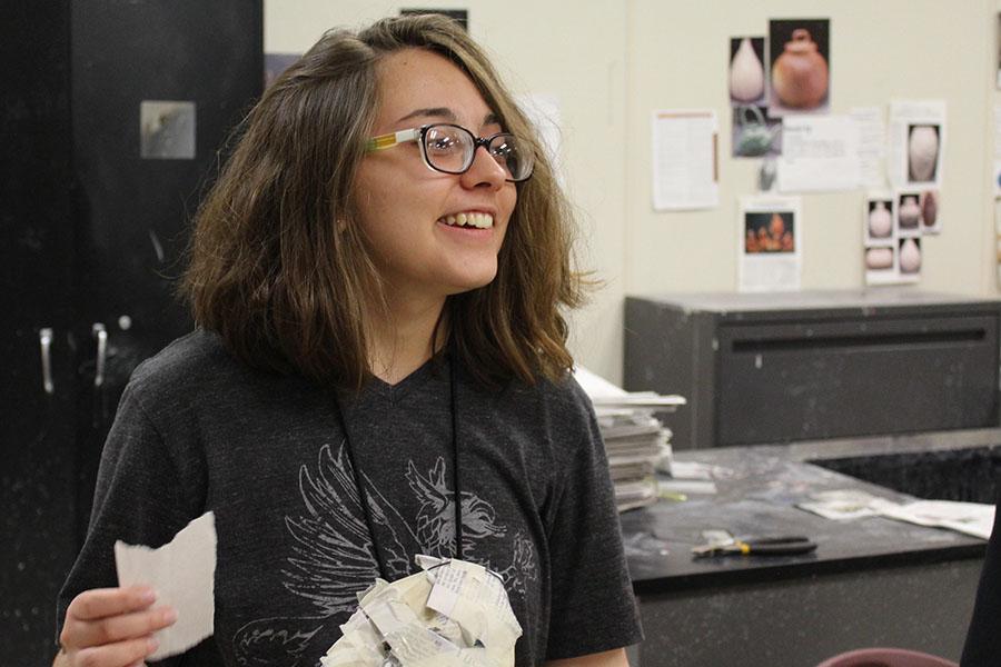 Junior Sarah Ross speaks to one of her friends while working on an art project.