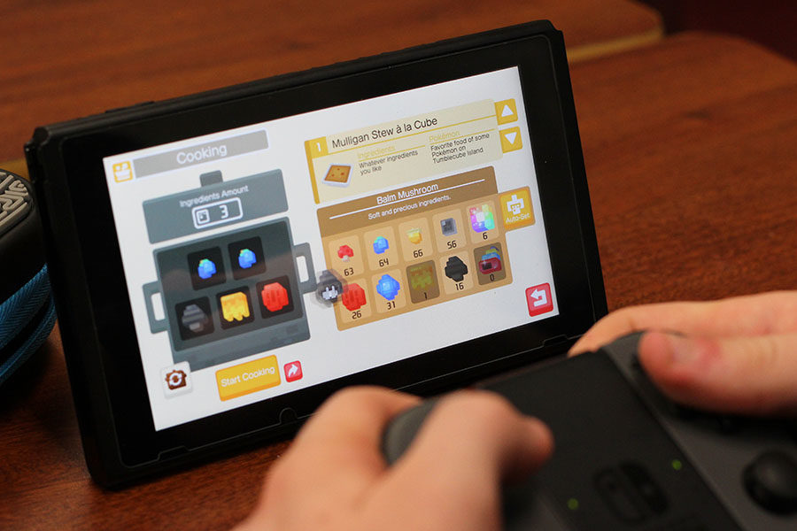 A+student+plays+%22Pok%C3%A9mon+Quest%22+on+the+Nintendo+Switch.