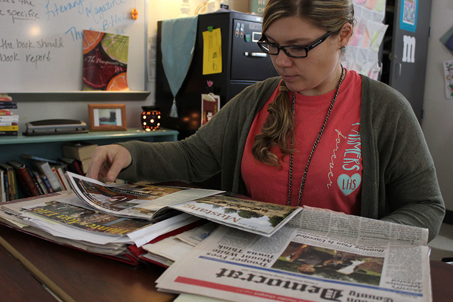 English+teacher+Mary+Davenport+reads+a+collection+of+her+articles.