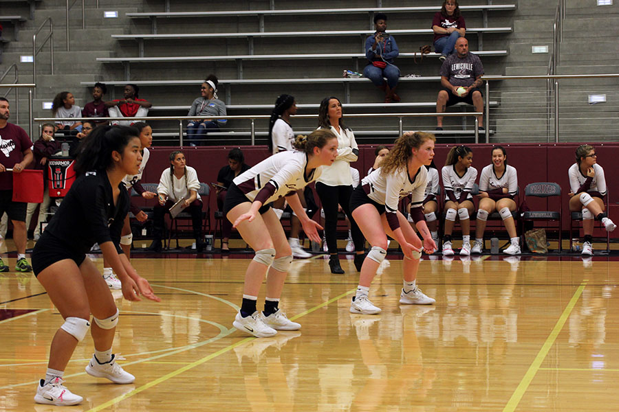 Senior Christina Cowsert and juniors Dawt Mawi and Emerson Coburn prepare for the play during the game against Marcus on Tuesday, Oct. 9.