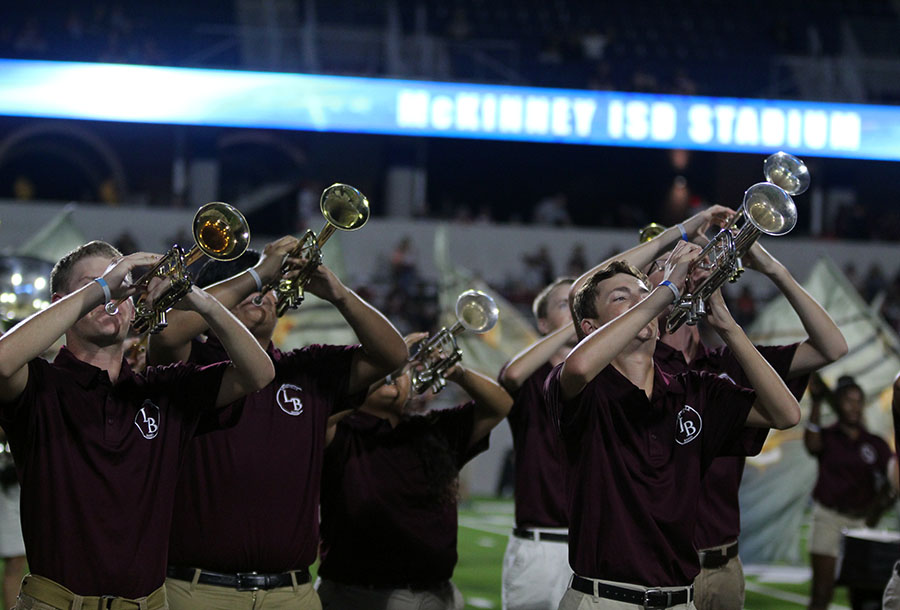 The trumpet section performs the band's halftime show,