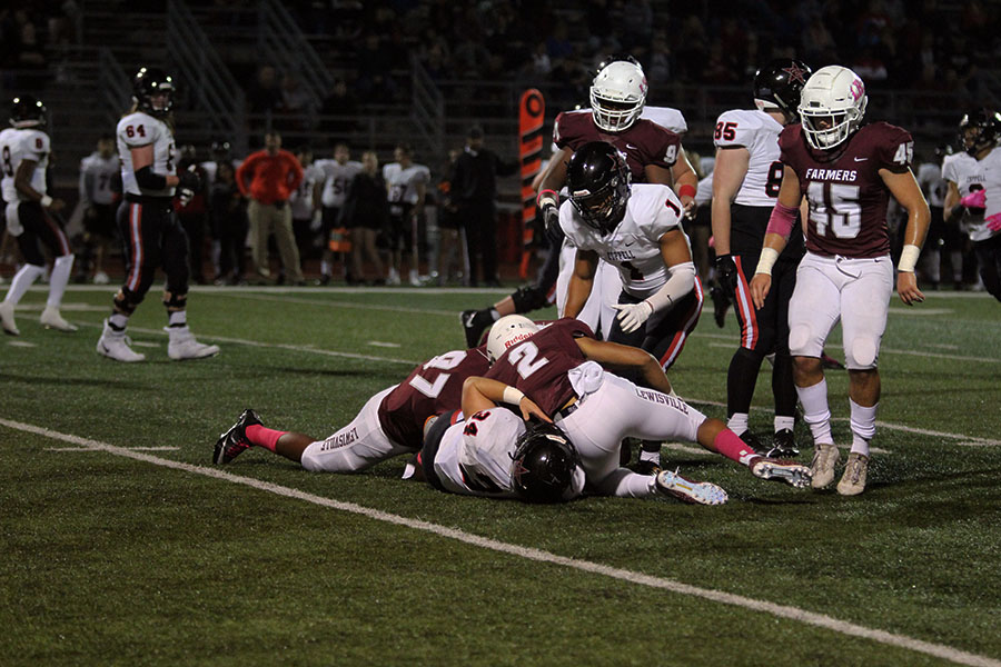 The Farmers tackle a Coppell player during the game on Friday, Oct. 12.