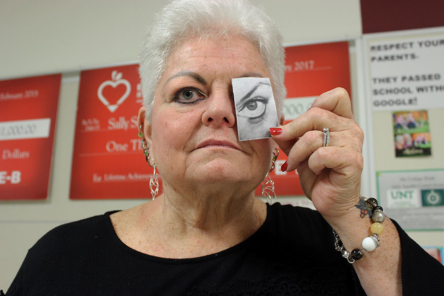 Debate+teacher+Sally+Squibb+holds+a+picture+of+her+eye+she+had+surgery+on.