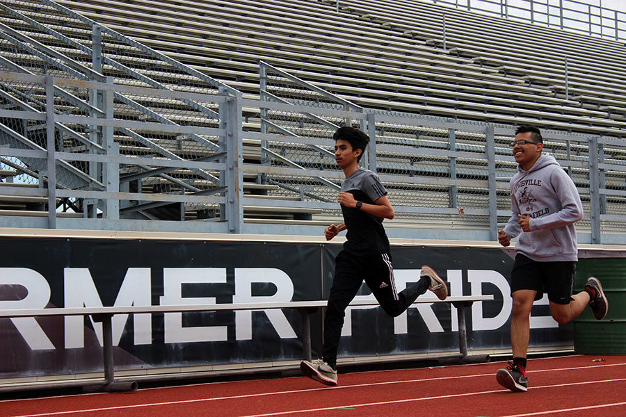 Juniors+Alan+Salinas+and+Elias+Gonsalez+practice+during+fourth+period+on+Tuesday%2C+March+19+for+their+upcoming+track+meet.