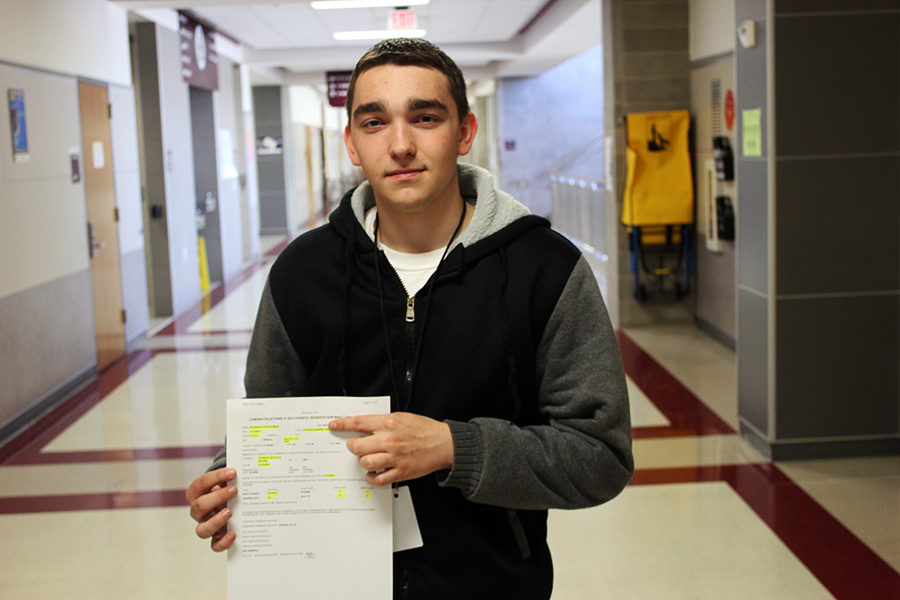 Senior+Dalton+Baham+holds+his+signed+contract+for+the+U.S.+Army.
