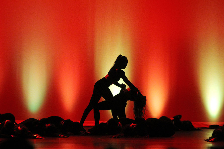 Senior lieutenant Saleema Bah pushes against junior lieutenant Carolyn Vaughan during varsity jazz's performance to