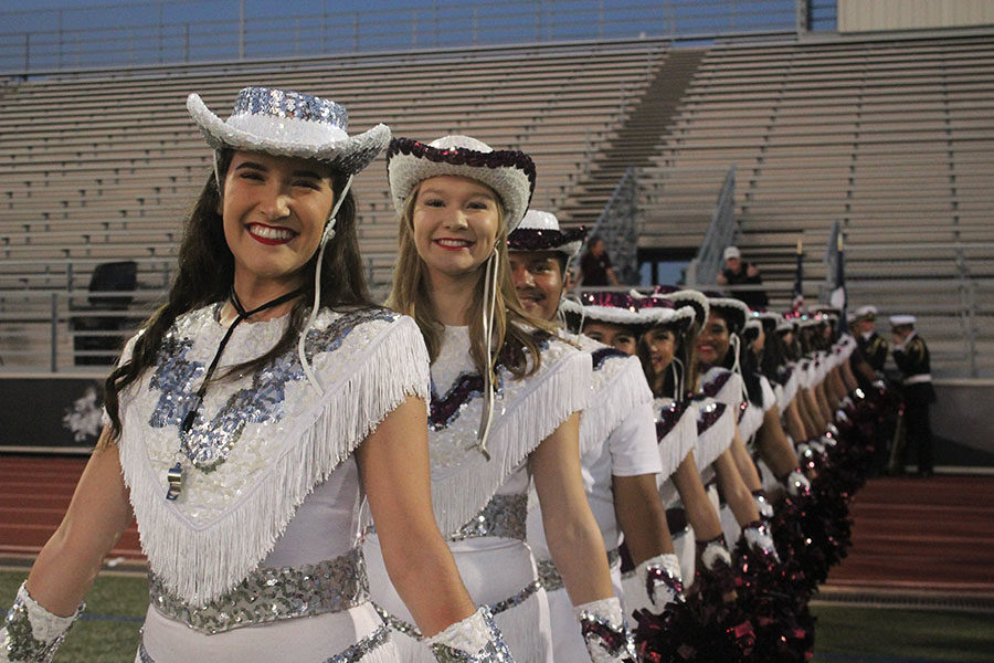 The Farmerettes line up behind senior captain Taylor Dill.