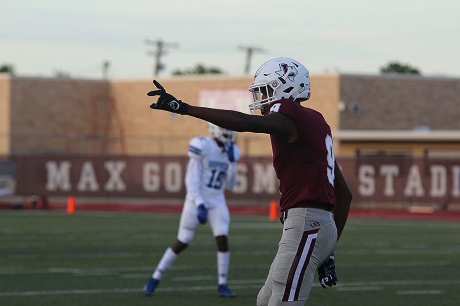 Sophomore+wide+receiver+Armani+Winfield+%289%29+raises+his+hand+before+the+play+begins+at+the+home+game+against+Grand+Prairie+on+Friday%2C+Aug.+30.