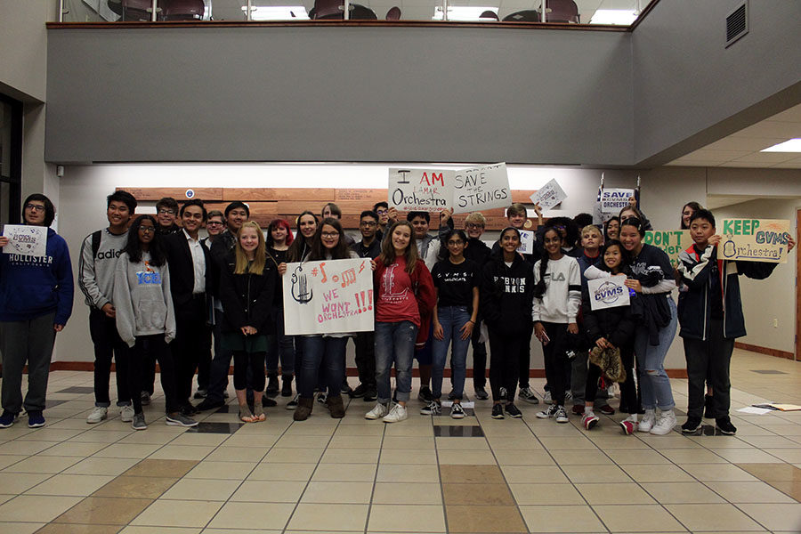 Students+from+across+the+district+pose+together+in+celebration+after+the+board+of+trustees+announced+it+would+reconsider+the+decision+to+consolidate+orchestra+programs+on+Monday%2C+Nov.+11.
