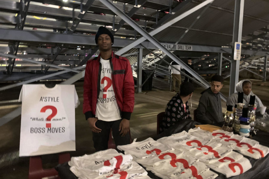 Senior+Atrion+Sorells+poses+for+a+picture+as+he+sells+his+T-shirts+from+his+clothing+line+A%27Style+Productions+during+the+home+game+against+Irving+Nimitz+on+Friday%2C+Oct.+25.+Courtesy+of+Valerie+Cooper.
